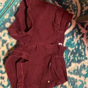 A dark magenta, button & zipper with four pockets